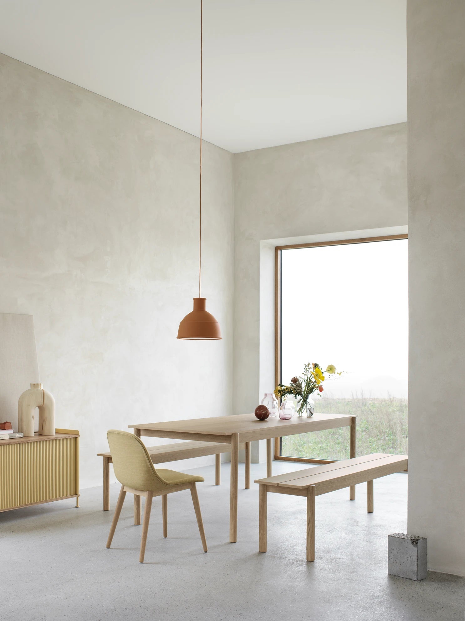 Lampada a sospensione in silicone Unfold Muuto Terracotta sopra a tavolo Linear in rovere